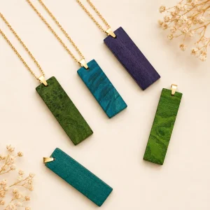 Image d'un ensemble de pendentif en bois teinté. Il y en a 2 vert, 2 bleu et 1 violet foncé